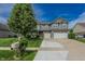 Charming two-story home featuring a landscaped front yard and a three-car garage and a yellow front door at 7320 Corwin Ct, Indianapolis, IN 46259