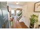 Bright foyer with hardwood floors, decorative accents, and a view into the adjacent living spaces at 7320 Corwin Ct, Indianapolis, IN 46259