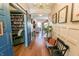 Beautiful foyer featuring hardwood floors, elegant lighting, and a view into the living room and library at 7320 Corwin Ct, Indianapolis, IN 46259