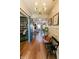 Beautiful foyer featuring hardwood floors, elegant lighting, and a view into the living room and library at 7320 Corwin Ct, Indianapolis, IN 46259