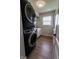 Modern laundry room featuring a stacked washer and dryer set against a white wall and cabinets at 7320 Corwin Ct, Indianapolis, IN 46259