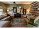 A cozy library with a wall of bookshelves, a comfy couch, an accent chair, and stylish decor at 7320 Corwin Ct, Indianapolis, IN 46259