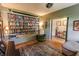 A library with a wall of bookshelves, an accent chair, and view to an open doorway at 7320 Corwin Ct, Indianapolis, IN 46259