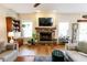 Inviting living area with stone fireplace, large windows, hardwood floors, and comfortable furniture at 7320 Corwin Ct, Indianapolis, IN 46259