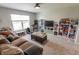 Comfortable living room features a cozy couch, carpet, and window providing natural light at 7320 Corwin Ct, Indianapolis, IN 46259