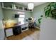 Bright home office with a custom wood desk, shelving, and plants, creating a productive work environment at 7320 Corwin Ct, Indianapolis, IN 46259