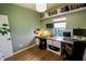 Well-lit home office with a custom wood desk, shelving, and dual monitors provides a productive workspace at 7320 Corwin Ct, Indianapolis, IN 46259