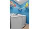 Bright laundry room with blue walls and modern appliances at 805 Sunvista Dr, Avon, IN 46123