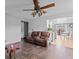 Comfortable living room featuring wood floors, a ceiling fan, and a view of the kitchen at 805 Sunvista Dr, Avon, IN 46123