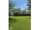 Well-maintained backyard featuring a lush green lawn, privacy fence and mature trees at 8130 Winterset Cir, Indianapolis, IN 46214