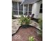 Backyard featuring a rock garden, patio furniture, beautiful landscaping, and a screened-in porch at 8130 Winterset Cir, Indianapolis, IN 46214