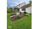 Landscaped backyard featuring a screened-in porch, a small garden and a walkway at 8130 Winterset Cir, Indianapolis, IN 46214