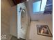 Relaxing soaking tub with window above and neutral stone surround at 8130 Winterset Cir, Indianapolis, IN 46214