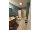 Traditional bathroom with a shower-tub combo and a gray vanity at 8130 Winterset Cir, Indianapolis, IN 46214