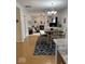 Open dining area with chandelier, table with four chairs, that flows into the living room with fireplace at 8130 Winterset Cir, Indianapolis, IN 46214