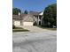 Charming two-story brick home featuring a two-car garage and well-manicured lawn at 8130 Winterset Cir, Indianapolis, IN 46214
