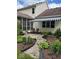 Exterior view of backyard and a screened-in porch with a striped awning, and gravel walkway at 8130 Winterset Cir, Indianapolis, IN 46214