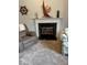 Close up of the fireplace with mantel and nautical decor in this cozy living space at 8130 Winterset Cir, Indianapolis, IN 46214