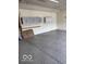 Clean garage featuring epoxy flooring and white wall-mounted storage cabinets at 8130 Winterset Cir, Indianapolis, IN 46214