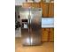 Spacious kitchen showcasing a stainless steel refrigerator with a water and ice dispenser and wooden cabinets at 8130 Winterset Cir, Indianapolis, IN 46214