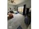 Bright living room with a fireplace, a ceiling fan, large windows and comfortable seating at 8130 Winterset Cir, Indianapolis, IN 46214