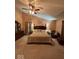 Spacious main bedroom with a king bed, fan, and en-suite bathroom at 8130 Winterset Cir, Indianapolis, IN 46214