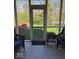 Cozy screened porch with backyard access and comfortable wicker seating at 8130 Winterset Cir, Indianapolis, IN 46214