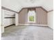 Inviting attic bedroom with a window, striped wallpaper, and cozy atmosphere at 814 Walnut St, Anderson, IN 46012