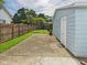 Side yard with a concrete patio, framed by a wooden fence, offering a private outdoor space at 814 Walnut St, Anderson, IN 46012