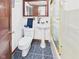 Cozy bathroom featuring a classic pedestal sink, tiled floors, and a shower with glass doors at 814 Walnut St, Anderson, IN 46012