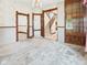 Bright bedroom featuring vintage wallpaper, chandelier, wooden trim and view to stairs at 814 Walnut St, Anderson, IN 46012