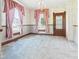 Charming bedroom with vintage wallpaper, a chandelier and two windows at 814 Walnut St, Anderson, IN 46012