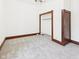Simple bedroom with a closet, neutral paint, and plush carpet at 814 Walnut St, Anderson, IN 46012