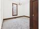 Bright bedroom with a large window, chandelier, and neutral walls and flooring at 814 Walnut St, Anderson, IN 46012