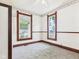 Comfortable bedroom with natural light from dual windows and classic wallpaper at 814 Walnut St, Anderson, IN 46012