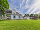 Charming blue two-story home with well-maintained lawn and detached garage on a sunny day at 814 Walnut St, Anderson, IN 46012
