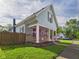 Charming two-story home featuring a covered porch, stone accents, and well-manicured lawn at 814 Walnut St, Anderson, IN 46012
