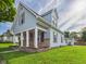 Charming two-story home with a welcoming porch, stone accents, and lush green lawn at 814 Walnut St, Anderson, IN 46012