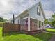 Charming two-story home features a covered front porch, stone accents, and mature trees at 814 Walnut St, Anderson, IN 46012