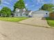 Charming light blue two-story home with a detached two-car garage and well-maintained lawn at 814 Walnut St, Anderson, IN 46012