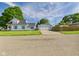 Charming light blue home with an attached garage and well-maintained front lawn at 814 Walnut St, Anderson, IN 46012