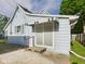 Charming light blue home exterior featuring a small patio and side entrance at 814 Walnut St, Anderson, IN 46012