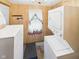 Functional laundry area with a stackable washer and dryer, plus wood paneling and a laundry-themed sign at 814 Walnut St, Anderson, IN 46012