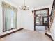 Cozy living room featuring a chandelier, large window, and vintage wooden trim at 814 Walnut St, Anderson, IN 46012