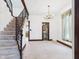 Inviting living room with a staircase, chandelier and a view to the bathroom at 814 Walnut St, Anderson, IN 46012