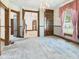 Cozy living room featuring vintage wallpaper, beautiful trim and a decorative chandelier at 814 Walnut St, Anderson, IN 46012