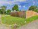 Lawn featuring a wooden fence, and mature trees at 814 Walnut St, Anderson, IN 46012