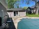 View of the backyard area with a covered pool in the center and an adjacent home exterior at 825 W Auman Dr, Carmel, IN 46032