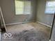 Vacant bedroom with neutral walls, stained carpet and a double window at 825 W Auman Dr, Carmel, IN 46032