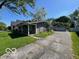 Side view of ranch style home with green lawn and detached garage at 825 W Auman Dr, Carmel, IN 46032
